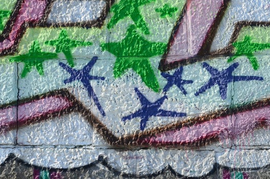 Fragment of graffiti drawings. The old wall decorated with paint stains in the style of street art culture. Colored background texture in green tones photo