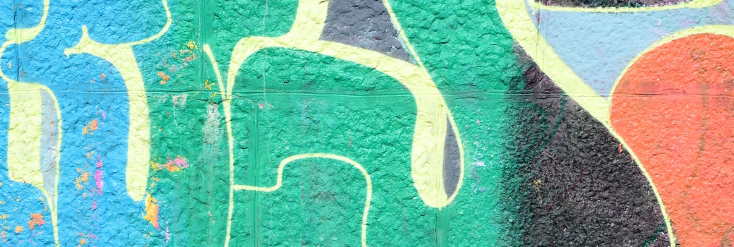 Fragment of graffiti drawings. The old wall decorated with paint stains in the style of street art culture. Colored background texture in green tones photo