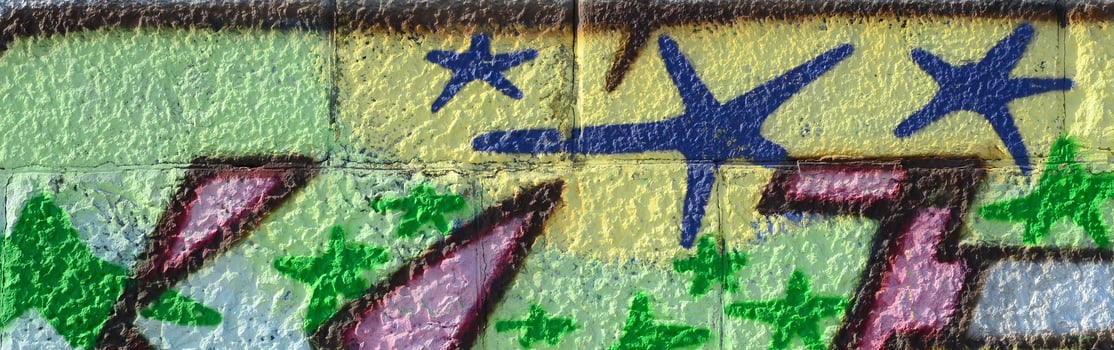 Fragment of graffiti drawings. The old wall decorated with paint stains in the style of street art culture. Colored background texture in green tones photo