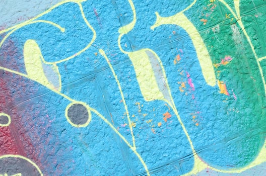 Fragment of graffiti drawings. The old wall decorated with paint stains in the style of street art culture. Colored background texture in cold tones photo