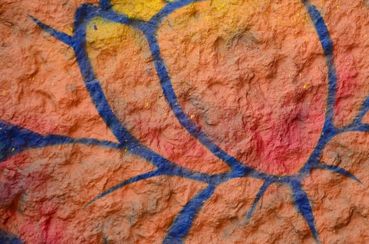 Fragment of graffiti drawings. The old wall decorated with paint stains in the style of street art culture. Orange flower photo