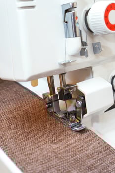 Overlock sewing machine in process. Professional equipment photo