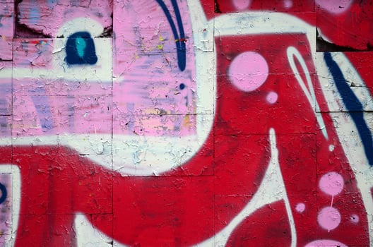 A fragment of graffiti drawing using contours, applied to the wall with the help of cans with aerosol paints over the colored filling areas. Background texture of street art and vandalism photo