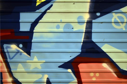 Some elements of a large and composite graffiti pattern on the wall, made with different colors of aerosol paints photo
