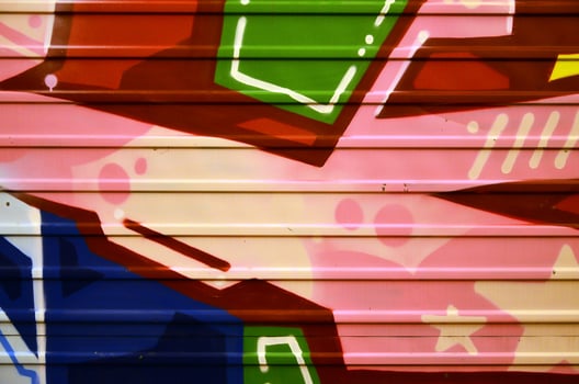 Some elements of a large and composite graffiti pattern on the wall, made with different colors of aerosol paints photo