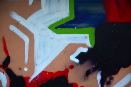 Some elements of a large and composite graffiti pattern on the wall, made with different colors of aerosol paints photo