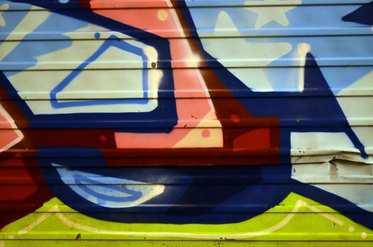 Background image with graffiti elements. Texture of the wall, painted in different colors of in the graffiti style. Concept of street culture, youth entertainment and illegal hooliganism photo