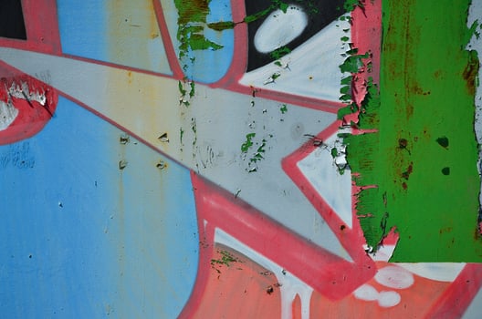 The old wall, painted in color graffiti drawing red aerosol paints. Background image on the theme of drawing graffiti and street art photo