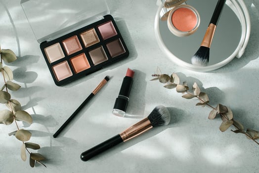 Makeup brushes and cosmetics on light background. Beauty, fashion concept. photo