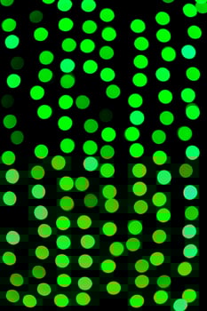 Unfocused abstract green bokeh on black background. defocused and blurred many round light photo