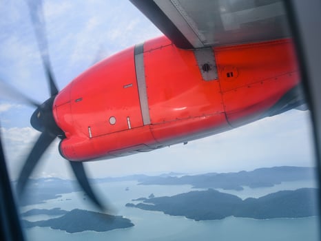 A propeller plane flying above Langkawi Island, Malaysia photo