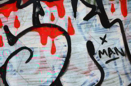 The old wall, painted in color graffiti drawing red aerosol paints. Background image on the theme of drawing graffiti and street art photo
