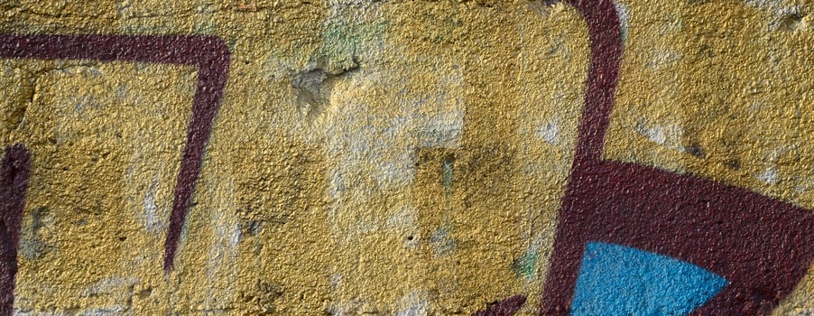 The old wall, painted in color graffiti drawing red aerosol paints. Background image on the theme of drawing graffiti and street art photo