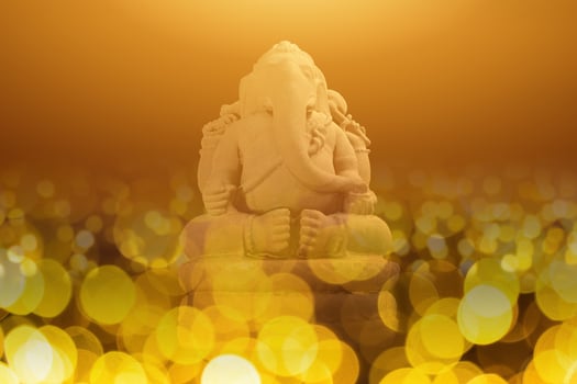 Selective focus on statue of Lord Ganesha, Ganesha Festival. Hindu religion and Indian celebration of Diwali festival concept on dark, red, yellow background. photo