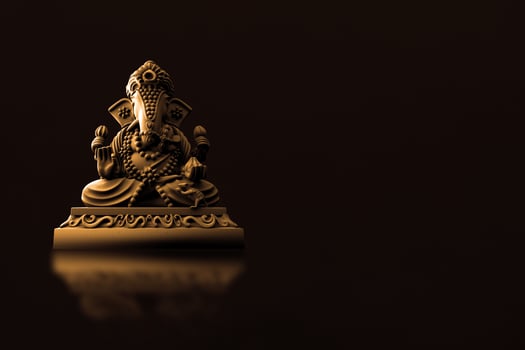 Selective focus on statue of Lord Ganesha, Ganesha Festival. Hindu religion and Indian celebration of Diwali festival concept on dark, red, yellow background. photo
