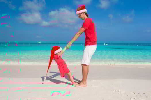 Little girl and happy dad in Santa Hat have fun at tropical beach photo