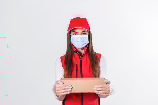 Delivery woman employee in red cap blank t-shirt uniform face mask gloves hold empty cardboard box isolated on white background studio Service quarantine pandemic coronavirus virus 2019-ncov concept photo
