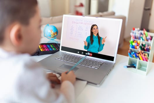 Pretty stylish schoolboy studying homework english during his online lesson at home, social distance during quarantine, self-isolation, online education concept, home schooler photo