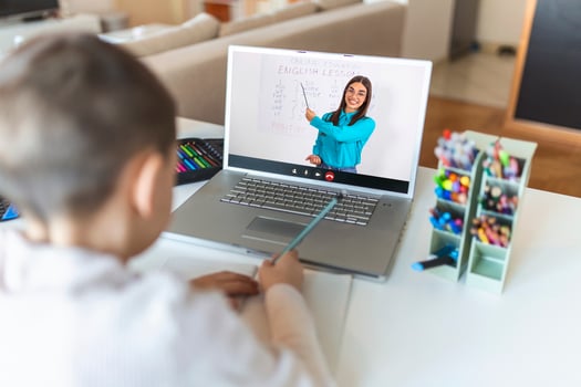 Online remote learning. School kids with computer having video conference chat with teacher and class group. Child studying from home. Homeschooling during quarantine and coronavirus outbreak. photo