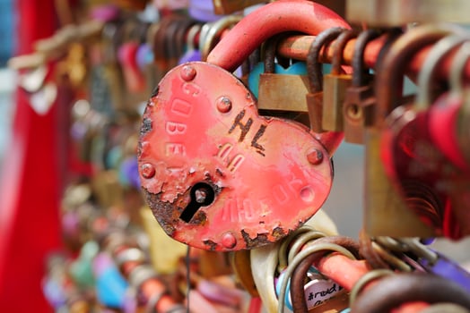 Many love padlocks locked on rusty iron gate in singapore photo
