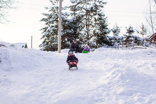 Little cute girl pulls a sled in warm winter day photo