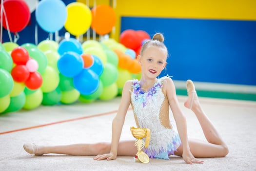 Beautiful little gymnast training on the carpet and ready for competitions photo