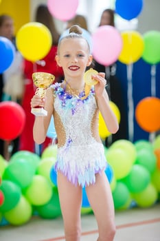 Beautiful little active gymnast girl with her performance on the carpet photo