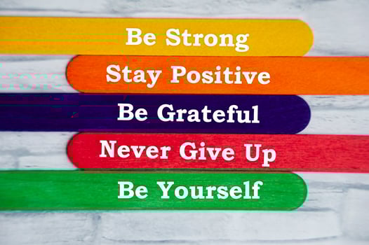 Motivational text on colorful sticks - Be strong, stay positive, be grateful, never give up and be yourself. Motivation and inspirational quote. photo