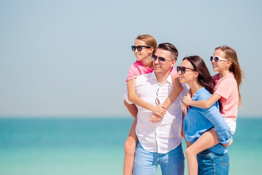Photo of happy family having fun on the beach. Summer Lifestyle