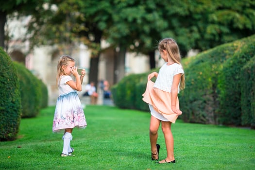 Little sisters on the grass photo