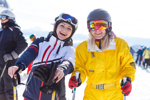 Half-length portrait of two female downhill skier friends photo