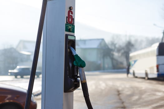 Fuel Dispenser with gas nozzle in gasoline station on winter season photo