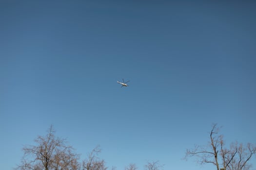 Small helicopter in blue sky. Aircraft. photo
