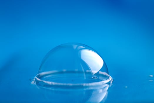 soap bubble close up. abstract blue water background photo