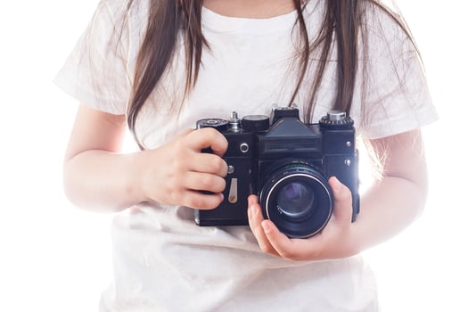 Girl hands holding camera with vintage color effect white background copy space photo