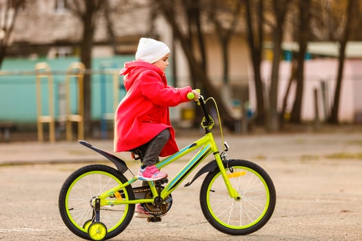 Child on a bicycle at asphalt road photo