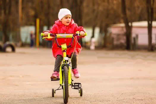 Little girl with her bicycle photo