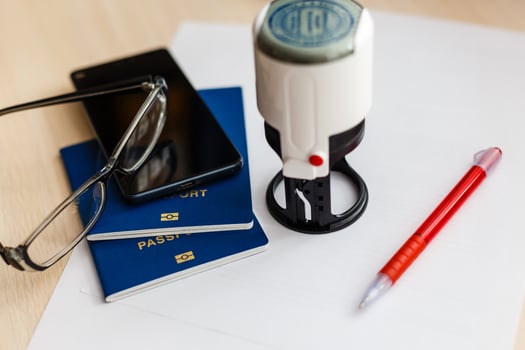 passport on declaration card with glasses and pen photo