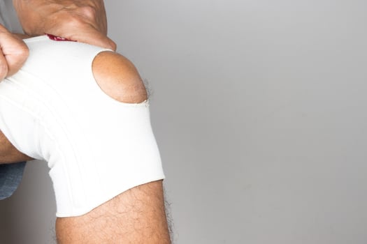 Man wearing an elastic type ace bandage on his knee photo