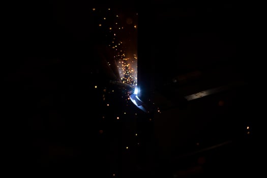 Metal welding in dark High temperature heating steel. Metal lights. photo