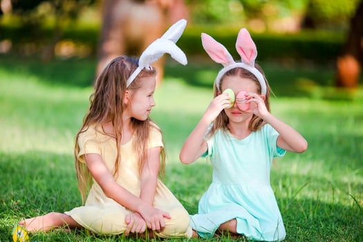 Two little girls wearing bunny ears on Easter outdoors photo