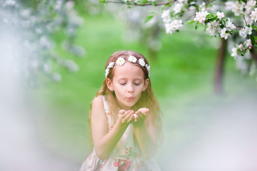 Cute girl in blooming apple tree garden enjoy the warm day photo