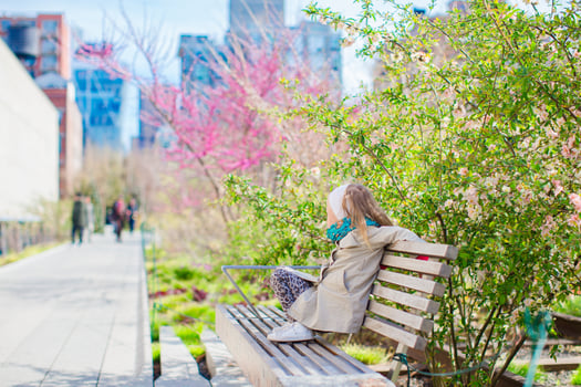 Sunny spring day on New York's High Line. Little girl enjoy early spring in the city outdoors photo