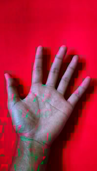 Portrait a straight hand line without a break is called a simian line, isolated on red background. photo