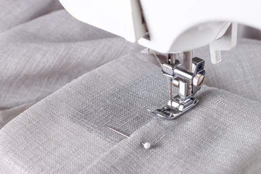 Modern sewing machine presser foot and item of clothes. Sewing process, handmade, hobby, business photo