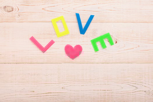 Word love on blue wooden background. Top view photo