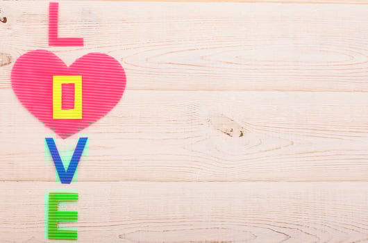 Word love on blue wooden background. Top view photo