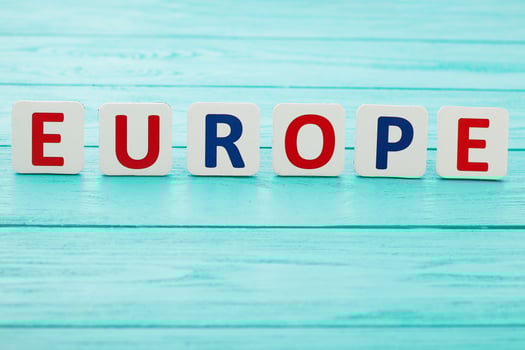 Word Europe on blue wooden background. Copy space and selective focus photo