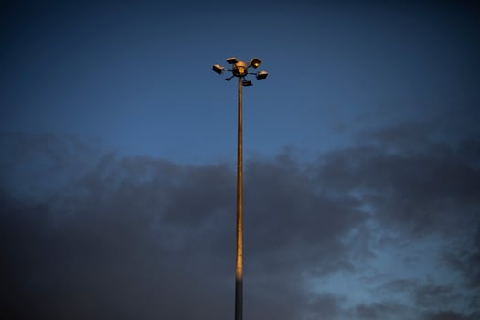 Pillar against sky. Street light in city. Large tower. photo