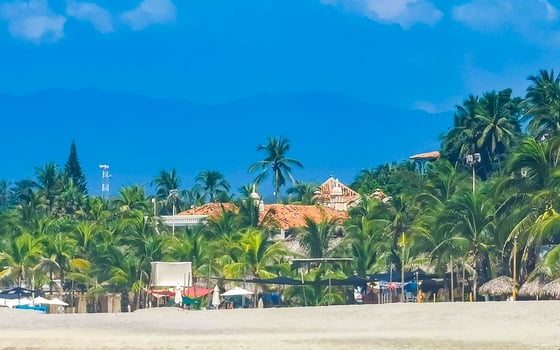 Sun beach people waves and boats in Puerto Escondido Mexico. photo